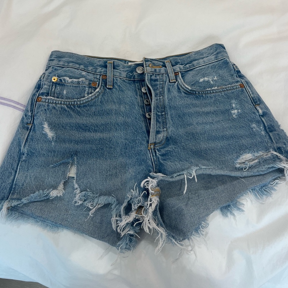 Agolde distressed light wash jean shorts. Mid waisted